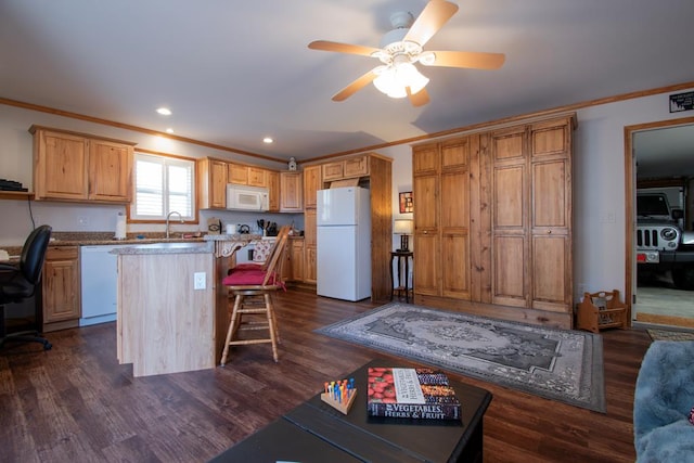 kitchen with a center island, dark wood-type flooring, white appliances, a kitchen bar, and ornamental molding