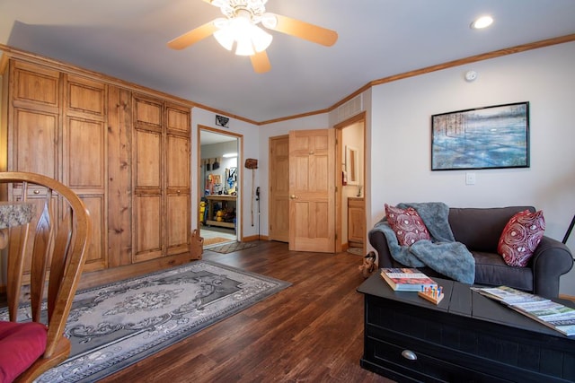 living room with dark hardwood / wood-style floors, ceiling fan, and crown molding