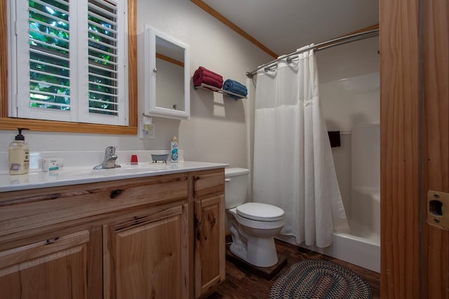 full bathroom with shower / bath combo, crown molding, hardwood / wood-style floors, toilet, and vanity