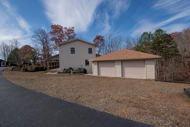 view of home's exterior featuring a garage and an outdoor structure