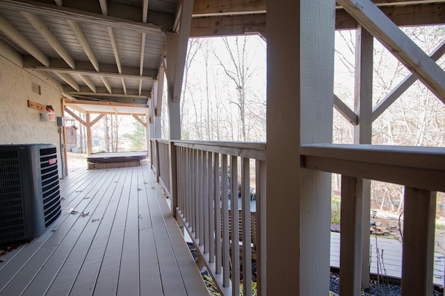 wooden deck featuring central air condition unit and a jacuzzi