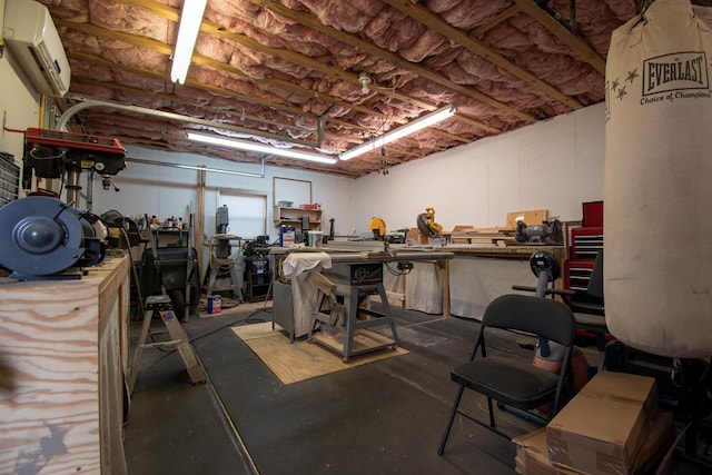 basement with a workshop area and a wall unit AC