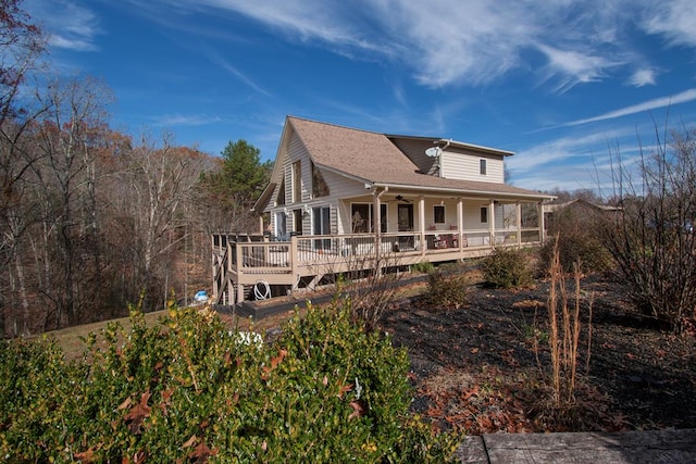 exterior space featuring ceiling fan and a deck