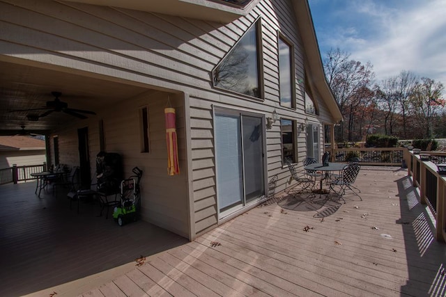 wooden deck featuring ceiling fan