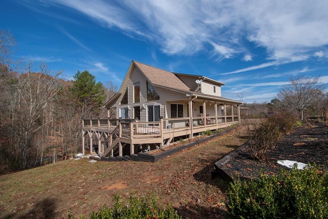 rear view of property featuring a deck