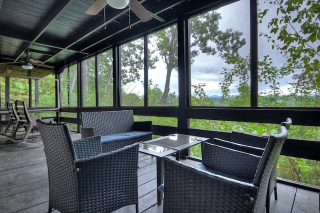 sunroom featuring ceiling fan