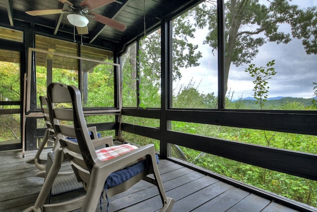 unfurnished sunroom featuring ceiling fan and a healthy amount of sunlight