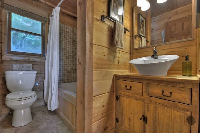 full bathroom featuring vanity, toilet, wood walls, shower / bath combo, and tile patterned flooring