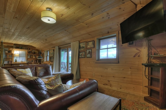 living room featuring wooden walls, plenty of natural light, vaulted ceiling, and wood ceiling