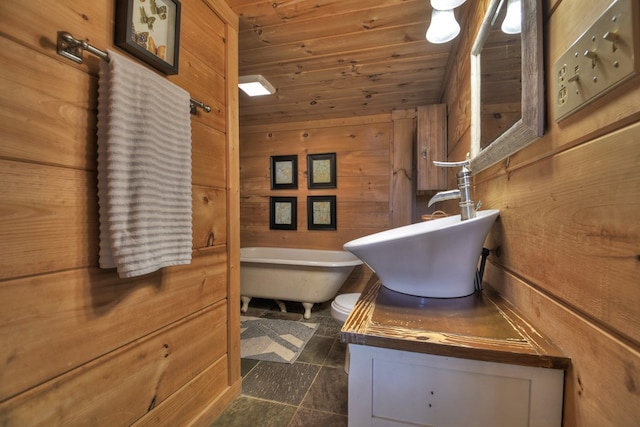 bathroom featuring a tub to relax in, wood walls, vanity, and wooden ceiling