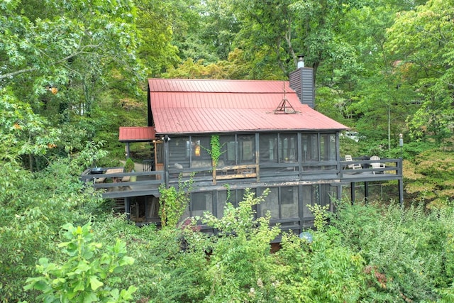 back of property with a sunroom