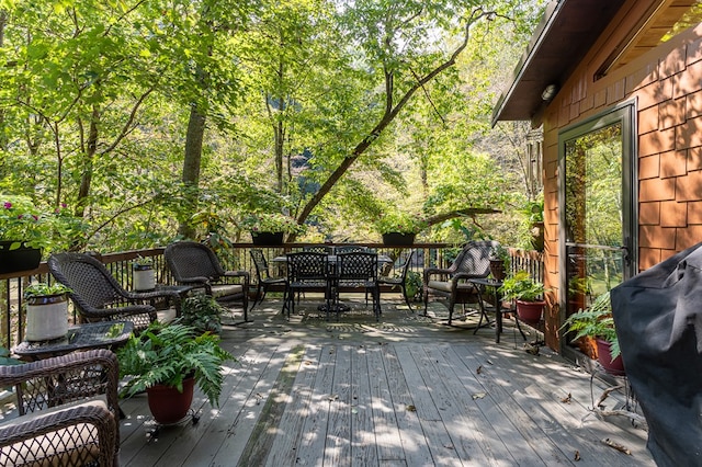 wooden deck featuring a grill