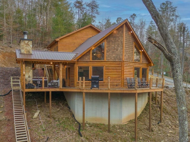 87 Lonesome Dove Path, Blue Ridge, GA 30513 - back of house with faux log siding, a deck, metal roof, and a chimney