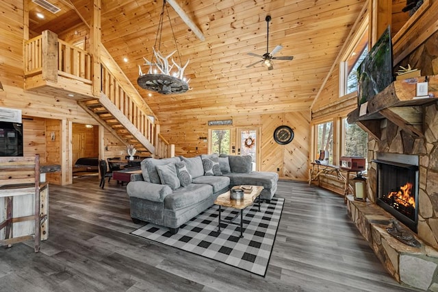 87 Lonesome Dove Path, Blue Ridge, GA 30513 - living room featuring stairway, plenty of natural light, high vaulted ceiling, wooden walls, and a stone fireplace