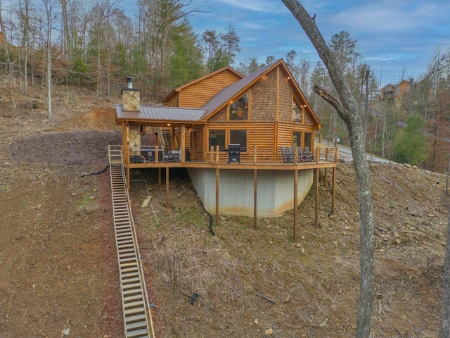 87 Lonesome Dove Path, Blue Ridge, GA 30513 - back of house with a deck, metal roof, faux log siding, and a chimney