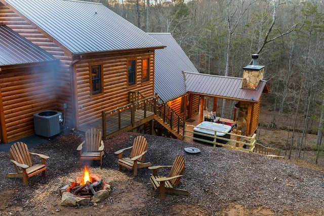 87 Lonesome Dove Path, Blue Ridge, GA 30513 - view of side of home with an outdoor fire pit, cooling unit, metal roof, a deck, and log veneer siding