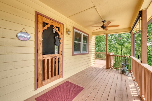 wooden terrace featuring ceiling fan and a porch