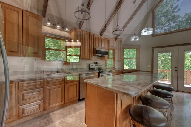 kitchen featuring stainless steel appliances, high vaulted ceiling, light stone countertops, brown cabinetry, and beam ceiling