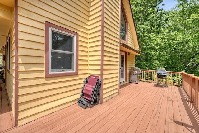 wooden terrace featuring a grill