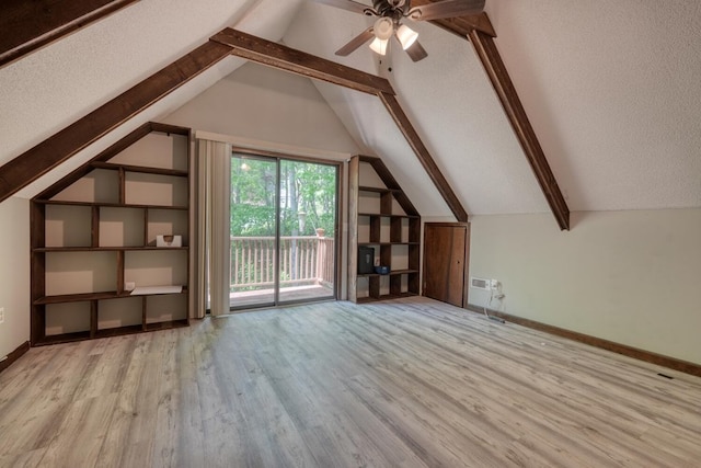 additional living space with wood finished floors, ceiling fan, baseboards, and a textured ceiling