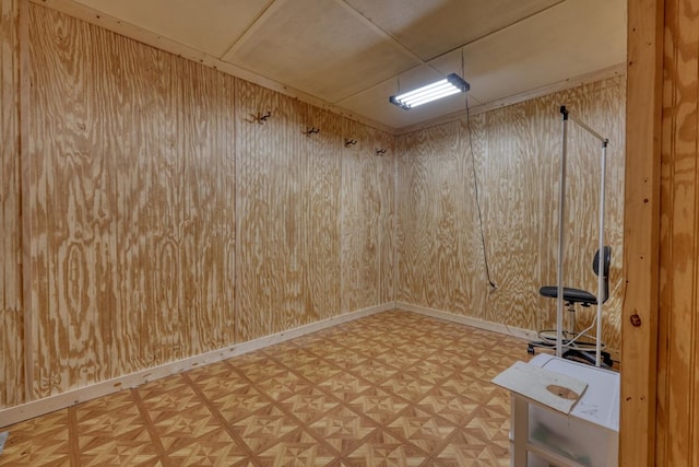 unfurnished room with wood walls
