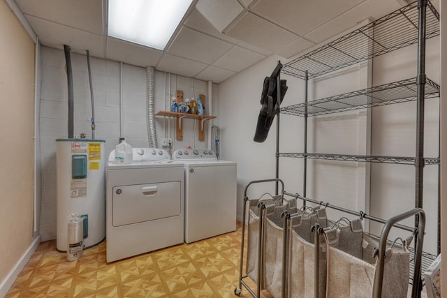 laundry room featuring electric water heater, washer and dryer, and baseboards