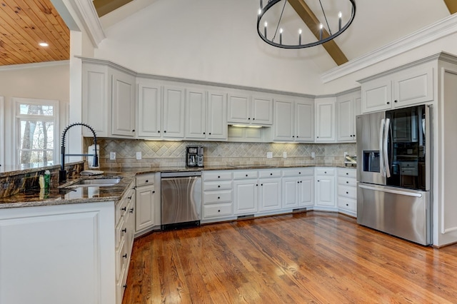 1492 Mcelroy Mountain Dr, Jasper, GA 30143 - kitchen featuring appliances with stainless steel finishes, a sink, a peninsula, dark stone countertops, and wood finished floors