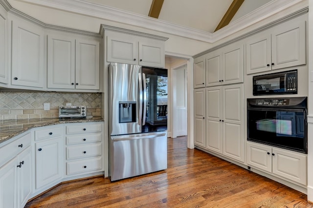 1492 Mcelroy Mountain Dr, Jasper, GA 30143 - kitchen featuring black appliances, lofted ceiling, light stone counters, light wood-style flooring, and backsplash
