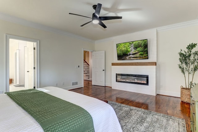 1492 Mcelroy Mountain Dr, Jasper, GA 30143 - bedroom featuring crown molding, wood finished floors, a glass covered fireplace, and baseboards