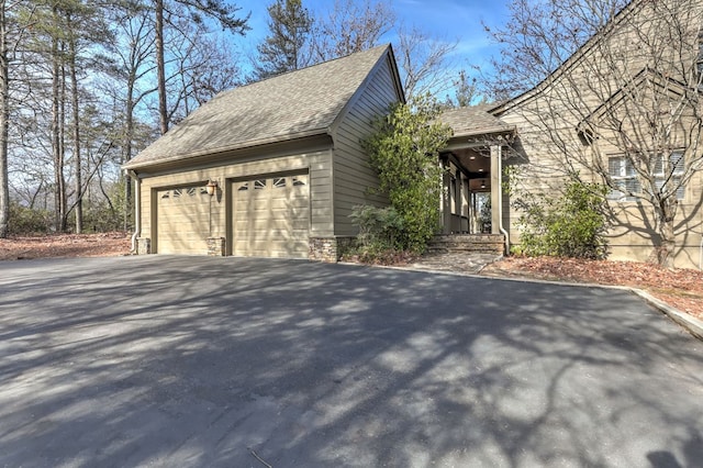 1492 Mcelroy Mountain Dr, Jasper, GA 30143 - view of home's exterior with driveway, a shingled roof, and a garage