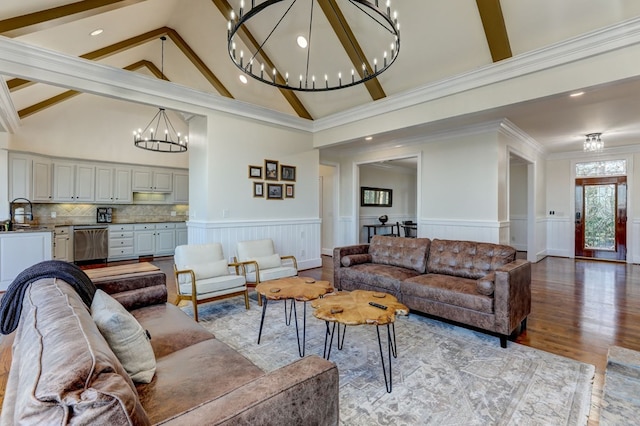 1492 Mcelroy Mountain Dr, Jasper, GA 30143 - living room featuring a chandelier, beamed ceiling, a wainscoted wall, high vaulted ceiling, and light wood-style flooring