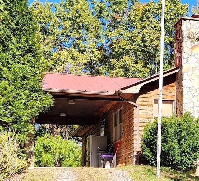 view of parking / parking lot featuring an attached carport