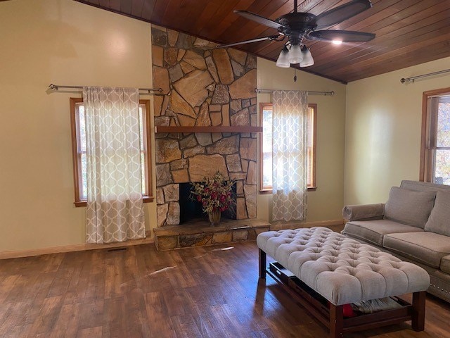 living area with vaulted ceiling, ceiling fan, wood ceiling, and baseboards