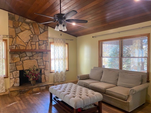 living area featuring wood ceiling, lofted ceiling, a ceiling fan, plenty of natural light, and wood finished floors