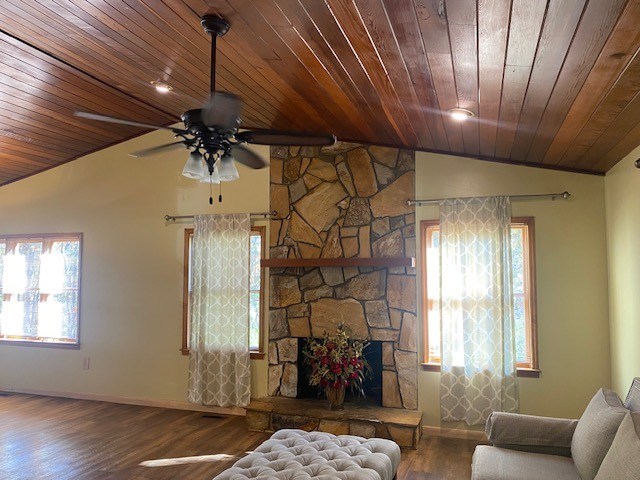 living room featuring a ceiling fan, vaulted ceiling, baseboards, wood ceiling, and wood finished floors