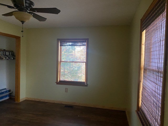unfurnished room featuring wood finished floors, ceiling fan, and baseboards
