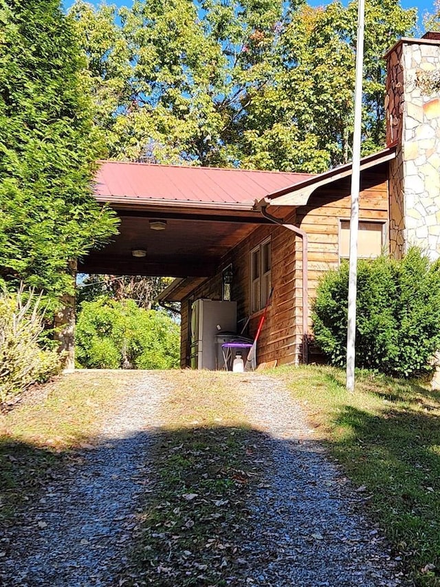 view of parking / parking lot with a carport and driveway