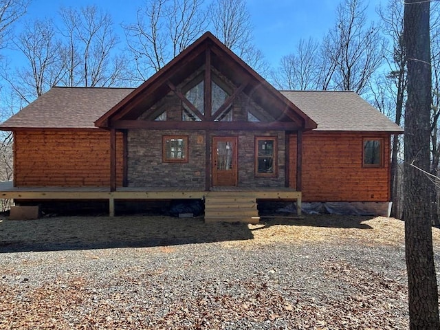 chalet / cabin with a shingled roof