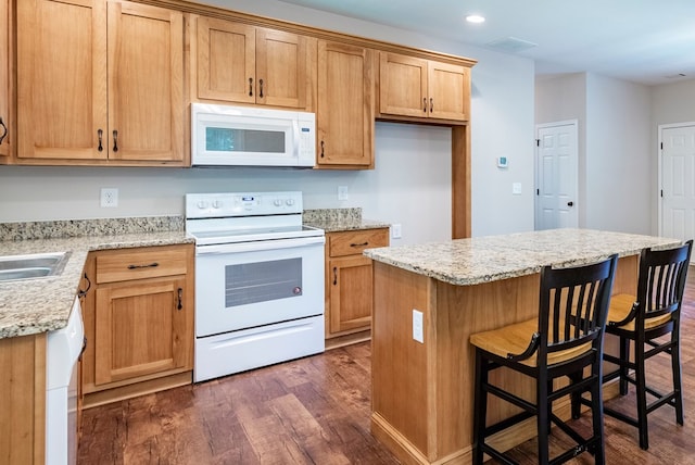 410 N Sharp Mountain Church Ln, Ball Ground, GA 30107 - kitchen with white appliances, dark wood-type flooring, a center island, a breakfast bar area, and recessed lighting