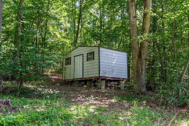 410 N Sharp Mountain Church Ln, Ball Ground, GA 30107 - view of shed featuring a wooded view