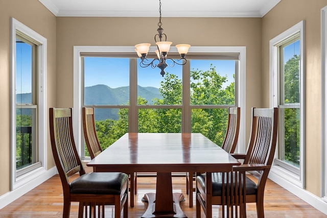 301 Shadow Mountain Rd, Dillard, GA 30537 - dining room with a chandelier, healthy amount of natural light, a mountain view, light wood-style floors, and crown molding