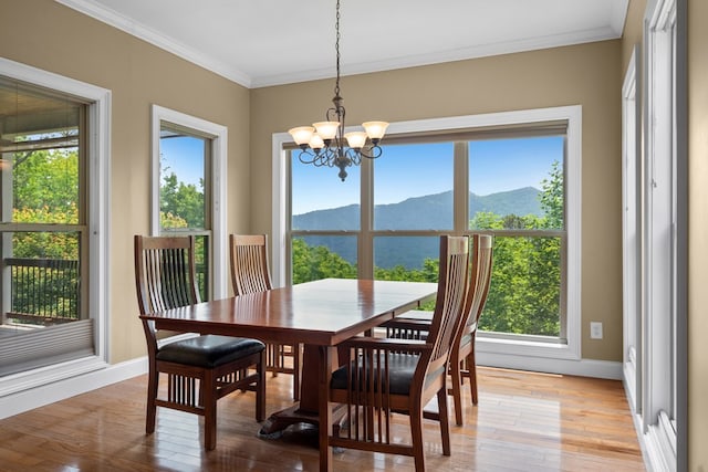 301 Shadow Mountain Rd, Dillard, GA 30537 - dining room with a mountain view, healthy amount of natural light, crown molding, a chandelier, and light wood-type flooring