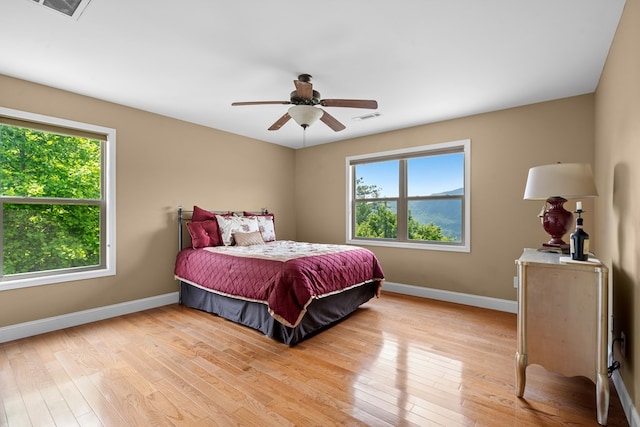 301 Shadow Mountain Rd, Dillard, GA 30537 - bedroom featuring multiple windows, baseboards, and light wood-style flooring