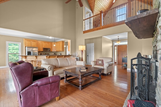 301 Shadow Mountain Rd, Dillard, GA 30537 - living area featuring high vaulted ceiling, light wood finished floors, baseboards, ceiling fan, and a fireplace