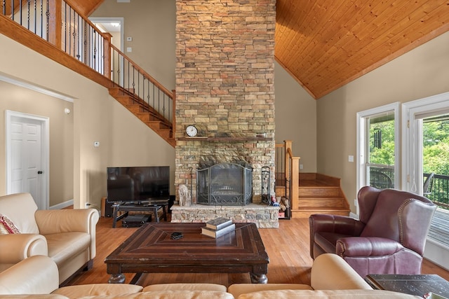 301 Shadow Mountain Rd, Dillard, GA 30537 - living room featuring high vaulted ceiling, stairs, wood finished floors, baseboards, and a stone fireplace