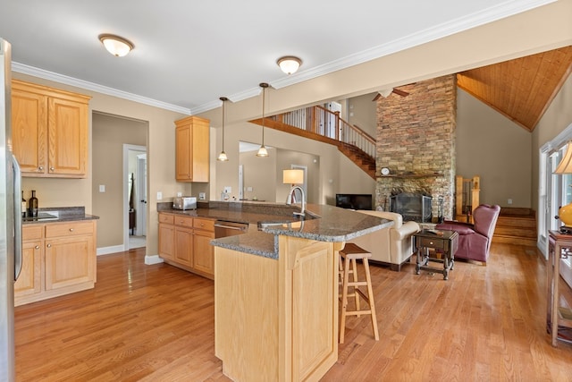 301 Shadow Mountain Rd, Dillard, GA 30537 - kitchen featuring a sink, light brown cabinets, a breakfast bar, open floor plan, and crown molding