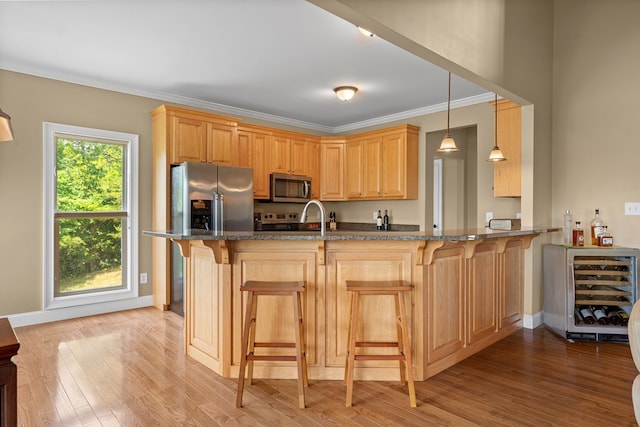 301 Shadow Mountain Rd, Dillard, GA 30537 - kitchen with appliances with stainless steel finishes, wine cooler, a peninsula, light wood-type flooring, and crown molding