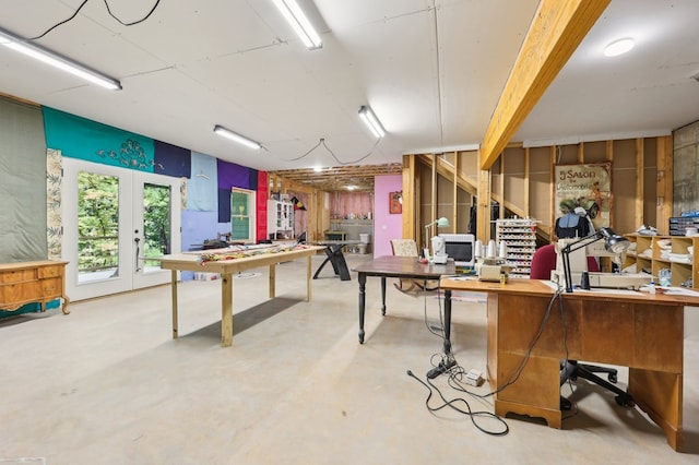 interior space with a workshop area, concrete flooring, and french doors