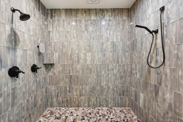 bathroom with tiled shower