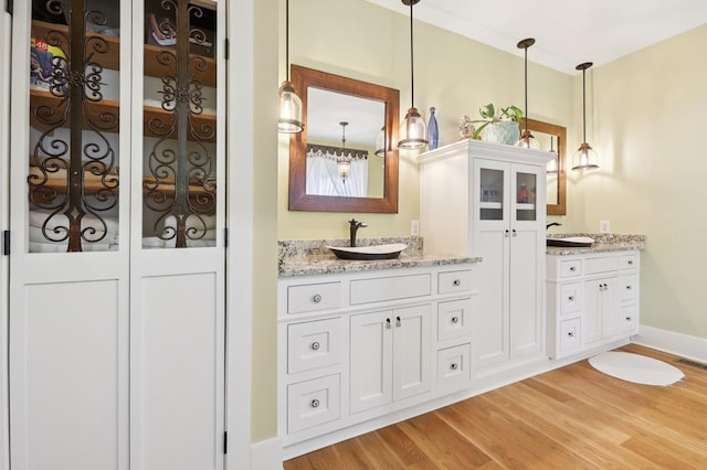 bathroom with vanity and hardwood / wood-style floors